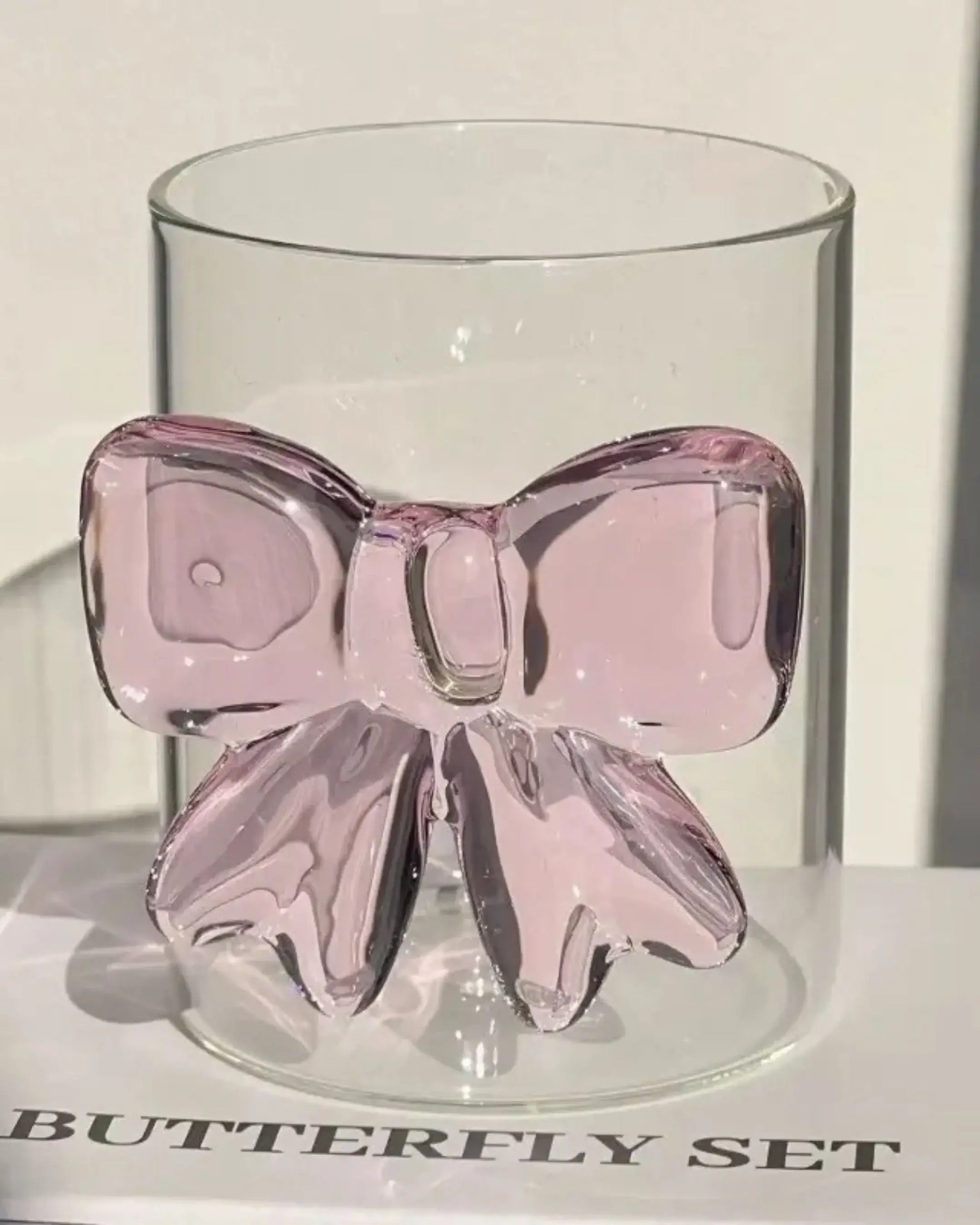 Pink 3D bow glass cup placed on text background - cute handmade cup gift idea